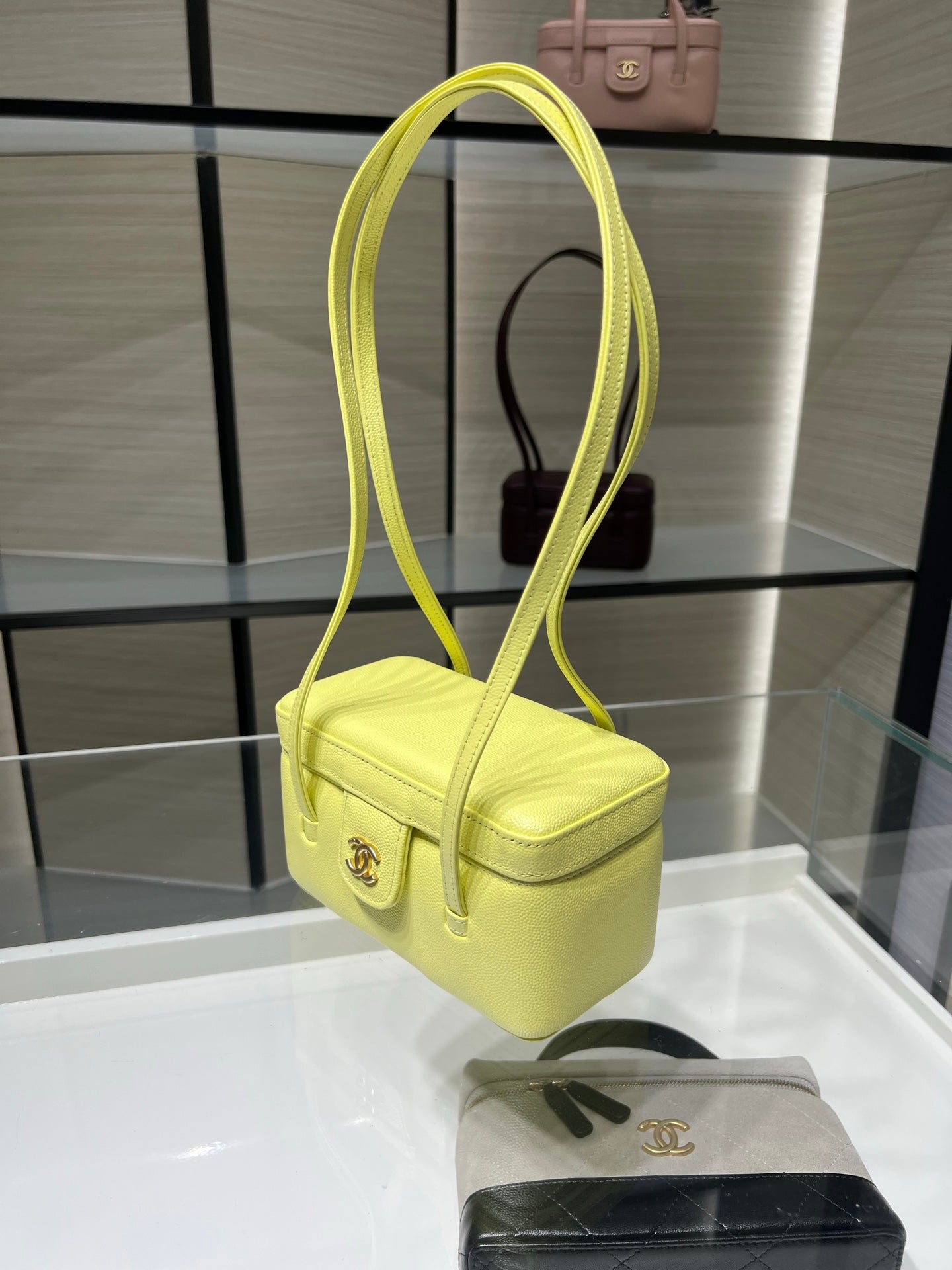 Yellow mini handbag with long shoulder strap and front flap pocket