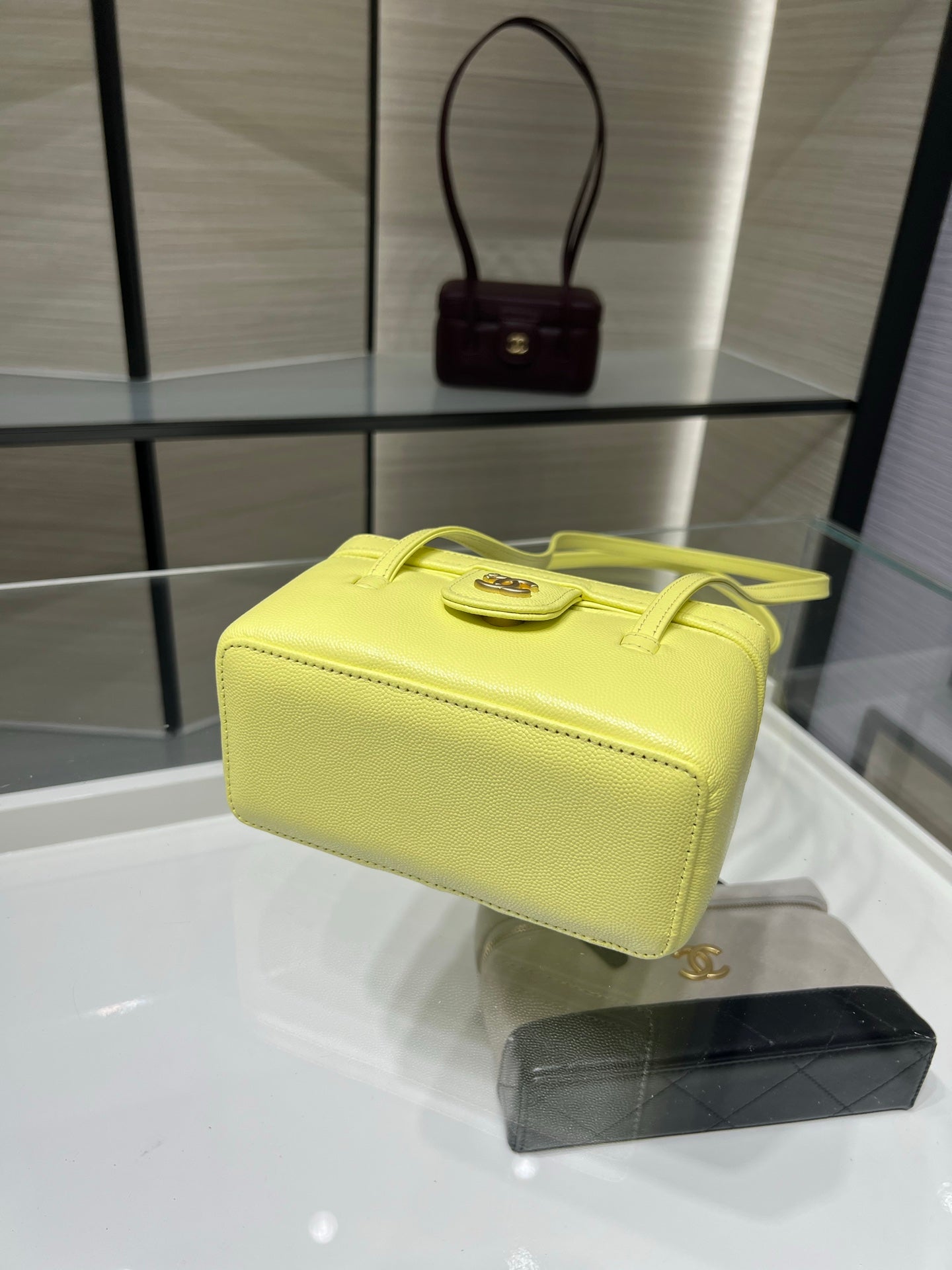 Light yellow structured handbag with short handles and gold logo hardware