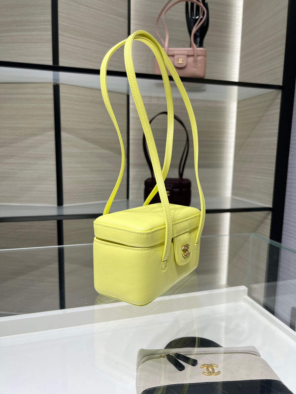 Yellow mini handbag with long shoulder strap and front flap clasp