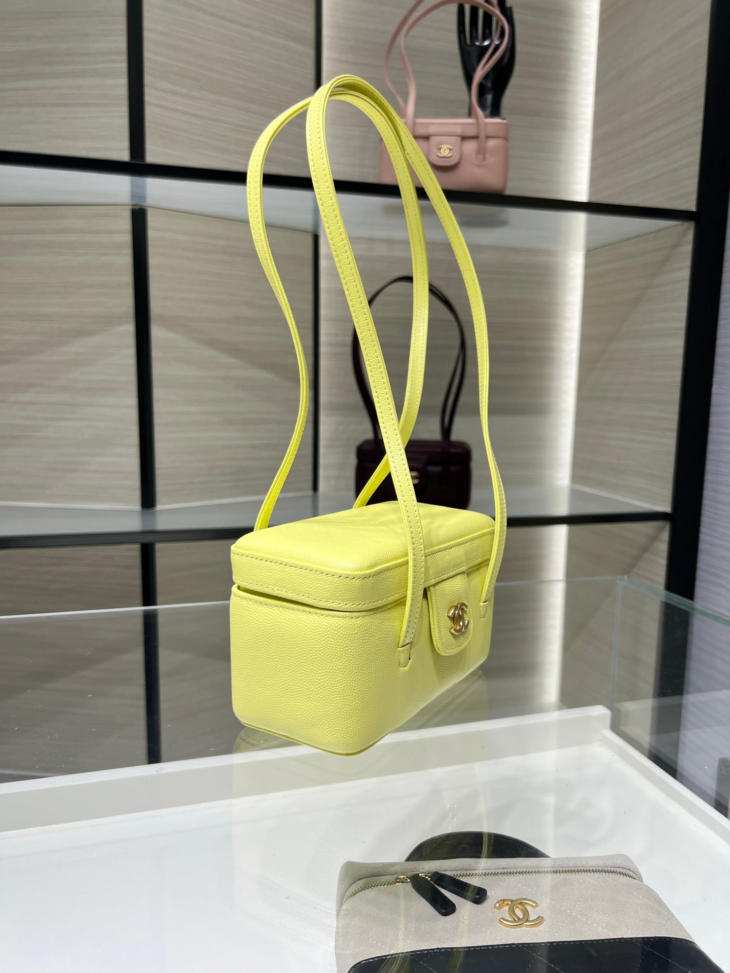 Yellow mini handbag with long shoulder strap and front flap clasp