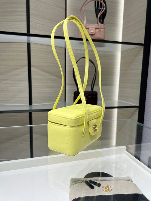 Yellow mini handbag with long shoulder strap and front flap clasp