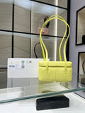 Yellow structured Chanel handbag with top handles and front flap logo