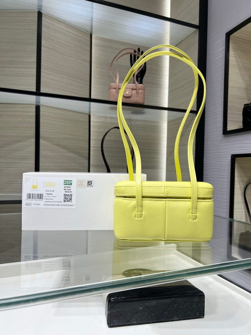 Yellow structured Chanel handbag with top handles and front flap logo