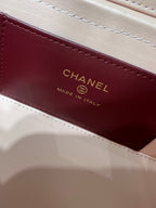 Chanel label on burgundy lining inside bag, reads CHANEL Made in Italy