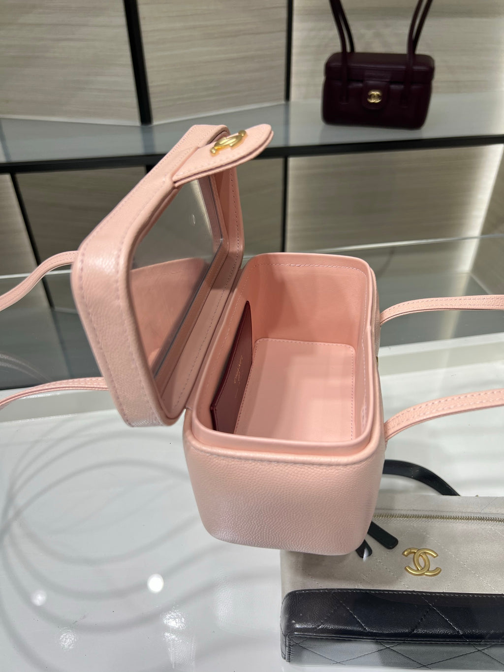 Chanel light pink mini bag opened to reveal light pink interior and gold clasp