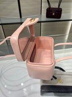 Chanel light pink mini bag opened to reveal light pink interior and gold clasp