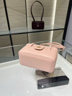 Chanel light pink structured mini bag with top handle and gold logo clasp