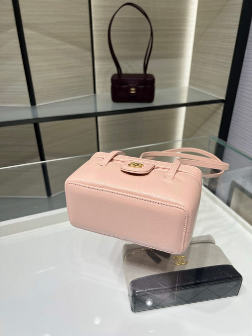 Chanel light pink structured mini bag with top handle and gold logo clasp