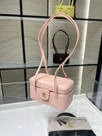 Chanel light pink mini shoulder bag with long strap and gold clasp detail