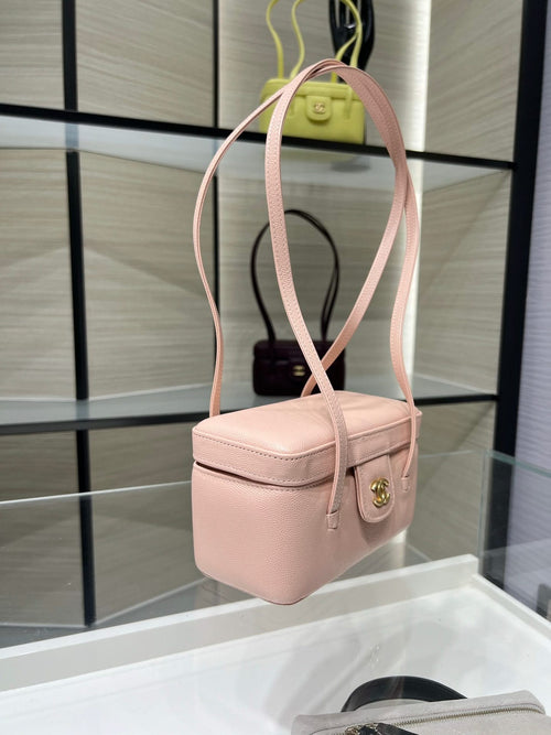 Chanel light pink mini shoulder bag with top handle, crossbody strap, and gold clasp