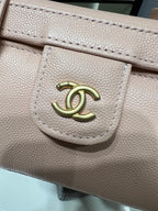 Chanel logo hardware on light pink textured bag flap with stitched edge