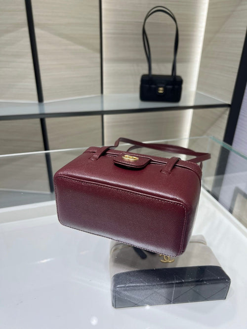 Burgundy Chanel handbag with short handles and gold front logo, top flap