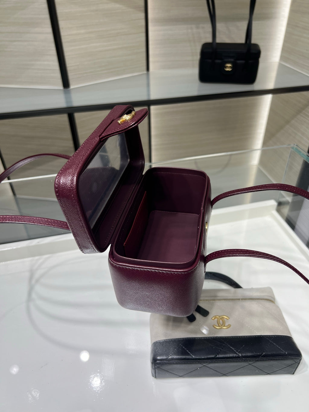 Burgundy Chanel bag open top showing burgundy interior and gold logo hardware