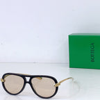 Bottega Veneta sunglasses, dark frames with light tan lenses and gold-tone hinges