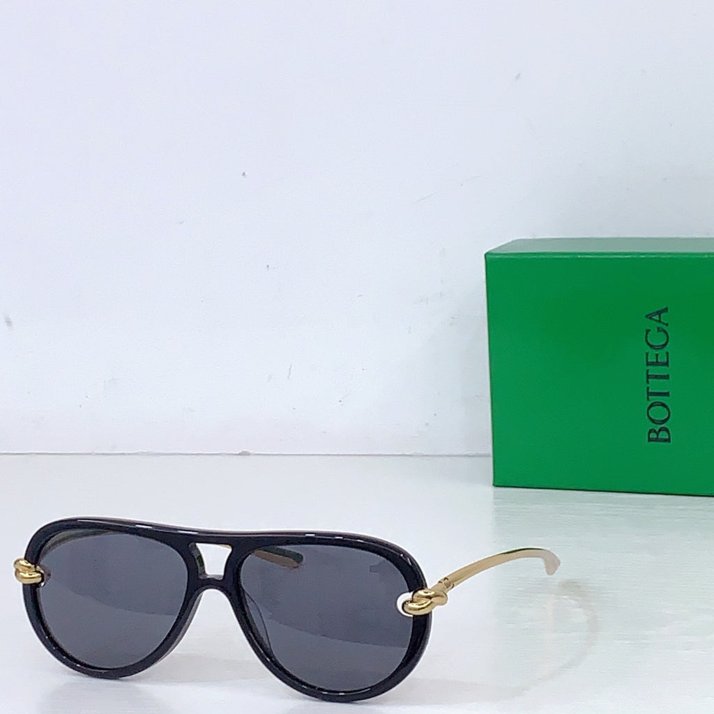 Bottega Veneta sunglasses with dark frames and blue-gray lenses, gold-tone temple details