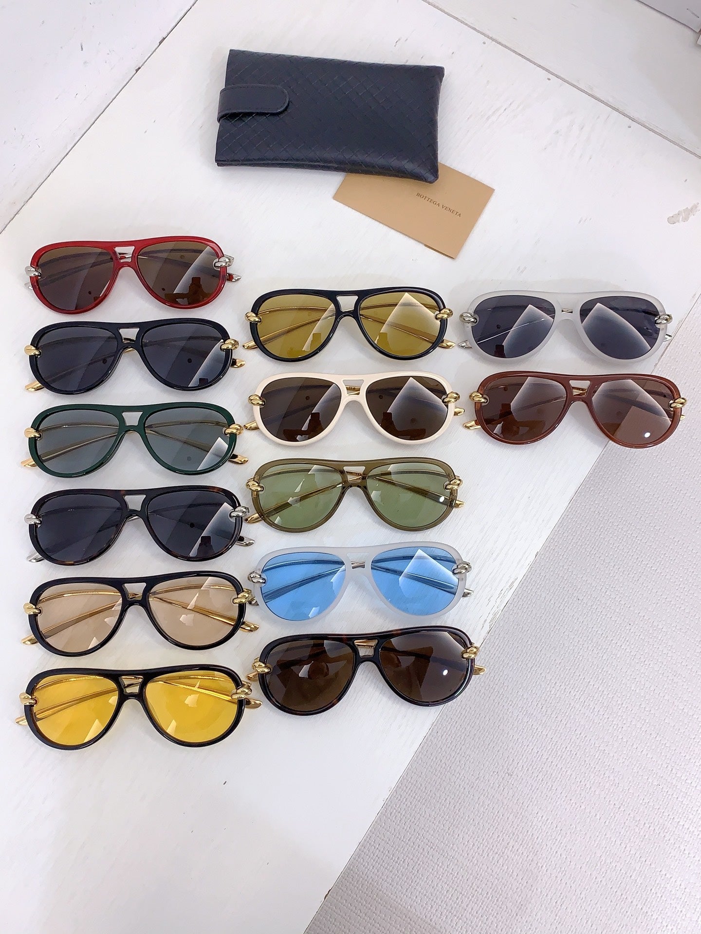 Bottega Veneta sunglasses assortment with multiple frame colors and tinted lenses, plus case