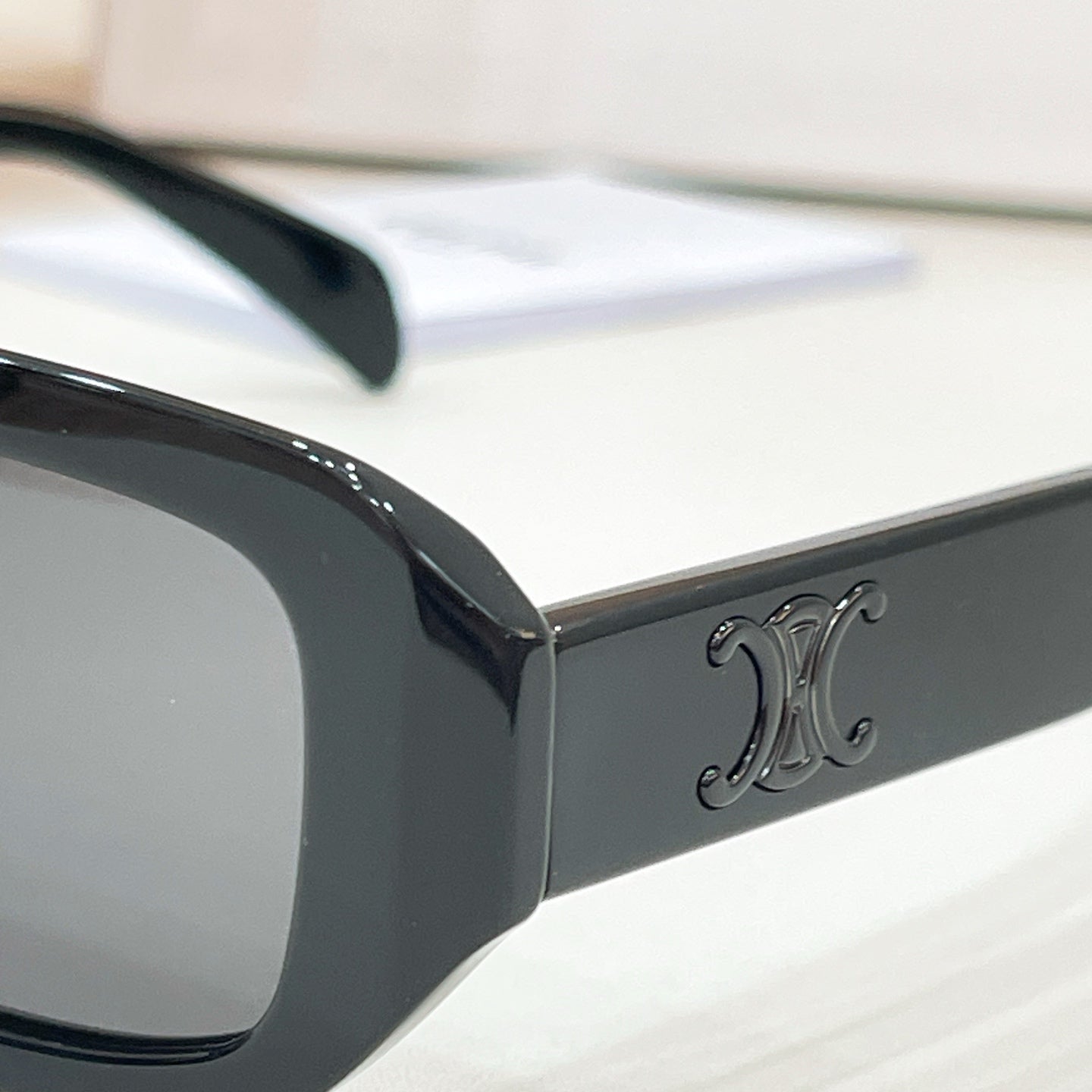 Celine sunglasses side arm with embossed logo on glossy black frame