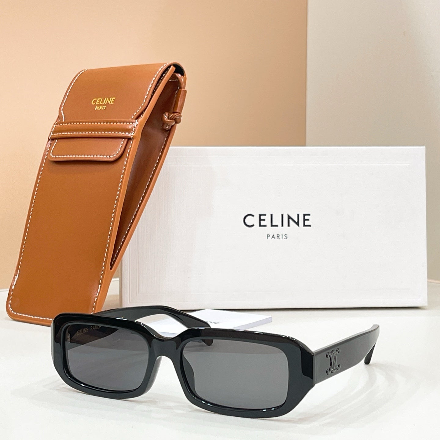 Celine sunglasses with black frames and dark lenses, with tan leather case