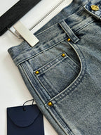 Light blue denim shorts with studded button placket and curved front pockets