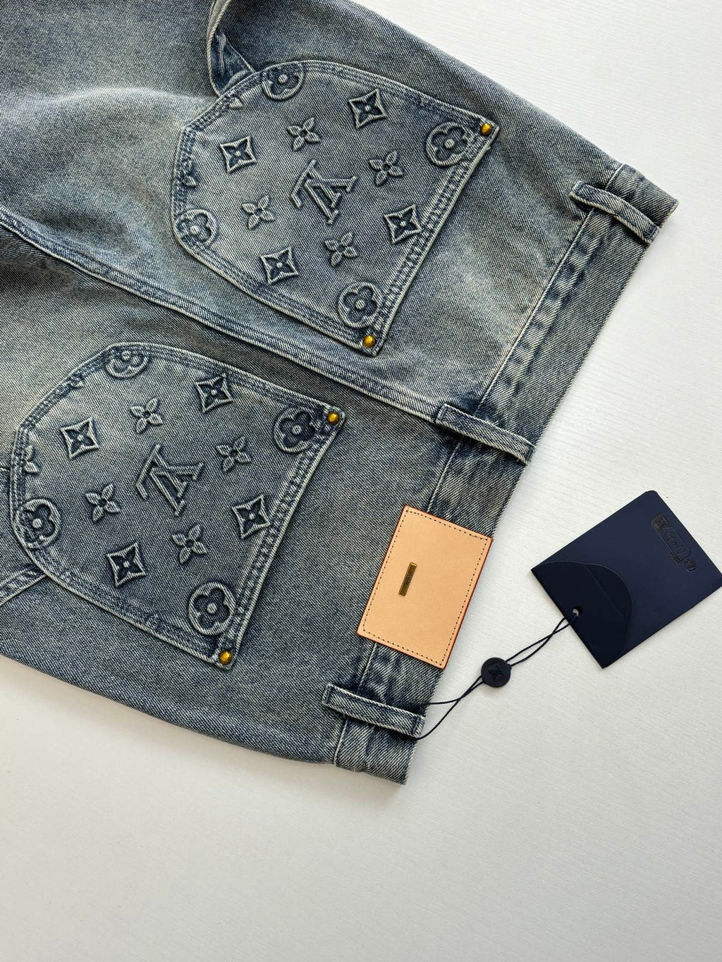 Folded denim shorts with monogram-print front and rear pocket panels