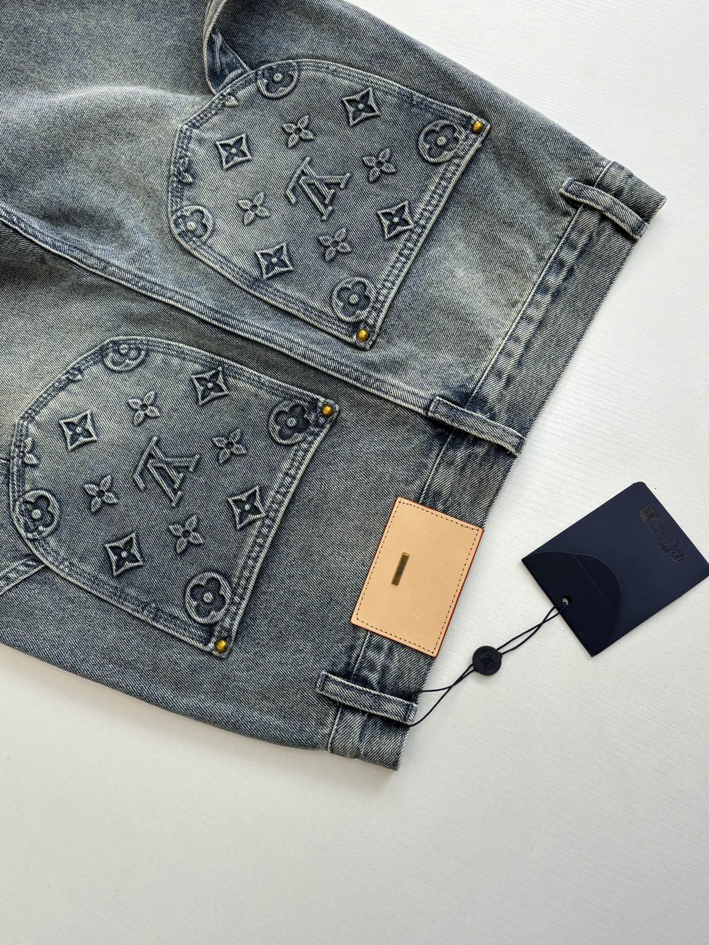 Folded denim shorts with monogram-print front and rear pocket panels