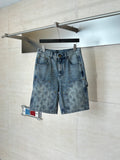 Light blue denim shorts with flap pockets and allover monogram-print design