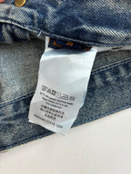 Denim pants care label inside waistband with washing instructions