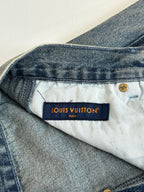 Louis Vuitton denim pants waistband with “LOUIS VUITTON” label and button