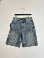 Light blue denim shorts on hanger with front button and monogram-print pockets