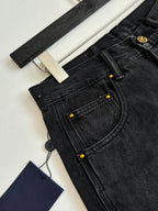Dark denim Louis Vuitton shorts close-up of buttoned pocket and stitched seams