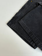 Folded dark denim Louis Vuitton shorts with textured monogram panels
