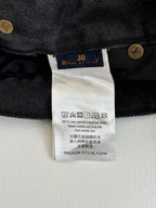 Denim pants care label with size 30 and washing symbols