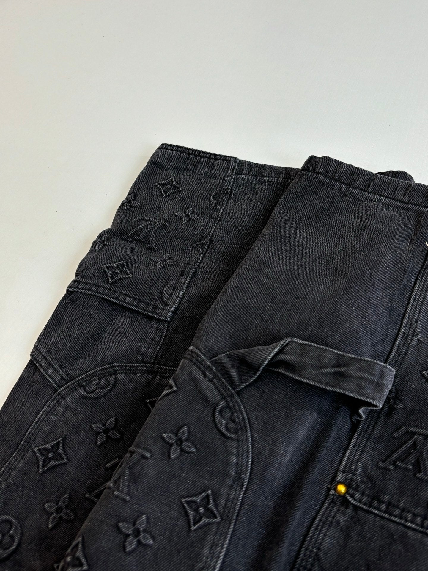 Dark denim pants with scattered Louis Vuitton monogram pattern