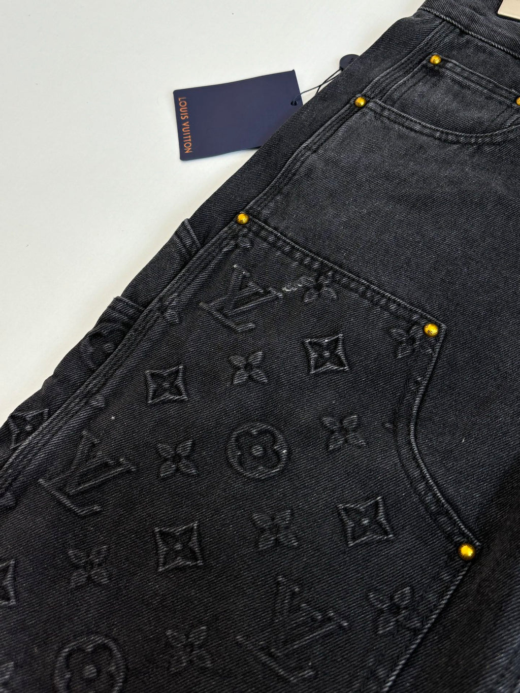 Black denim Louis Vuitton shorts close-up of embossed monogram pocket panel