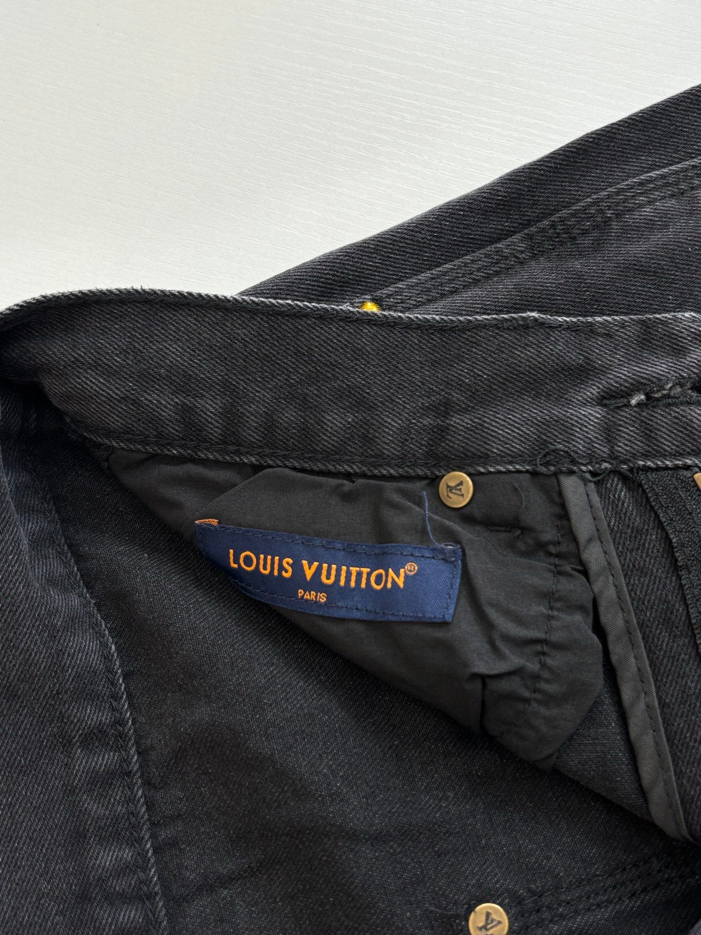 Denim pants with Louis Vuitton Paris fabric label and gold button