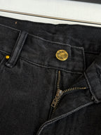 Dark denim shorts waistband detail with gold button and front zipper