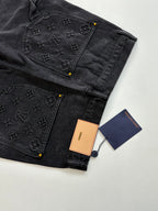Dark denim Louis Vuitton shorts with monogram patchwork and hanging brand tags