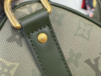 Louis Vuitton tote bag close-up: dark green textured leather strap with gold round logo