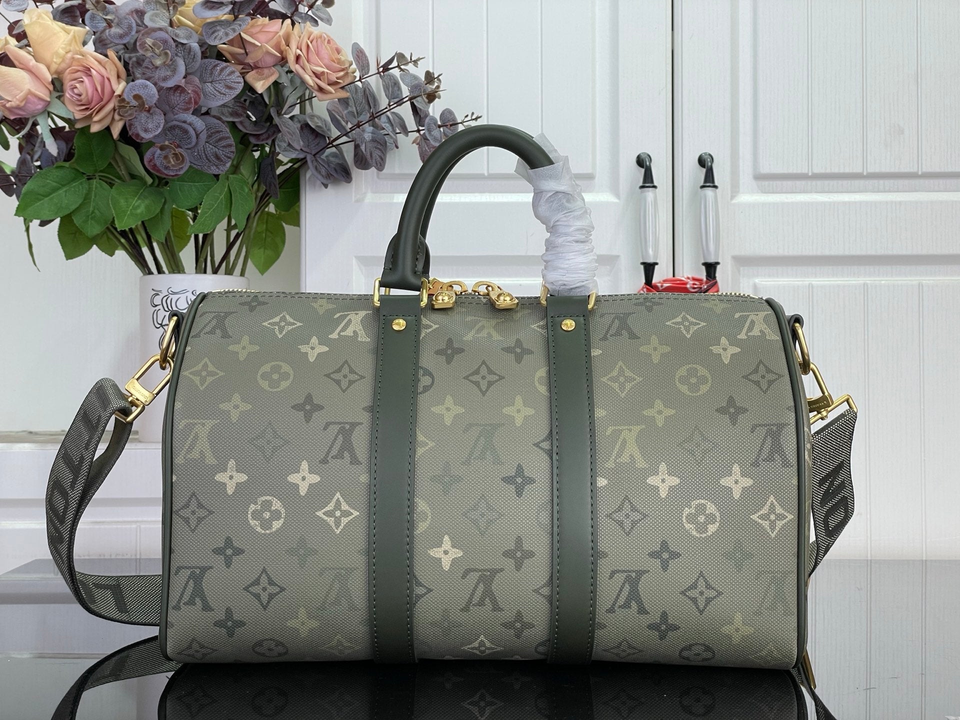 Louis Vuitton monogram tote bag, dark green front view with gold-tone zipper pull