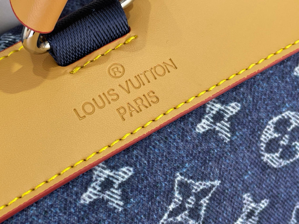 Tan leather logo patch reading Louis Vuitton Paris with yellow edge stitching