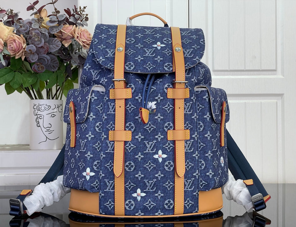 Louis Vuitton monogram canvas backpack with tan leather trim and top handle