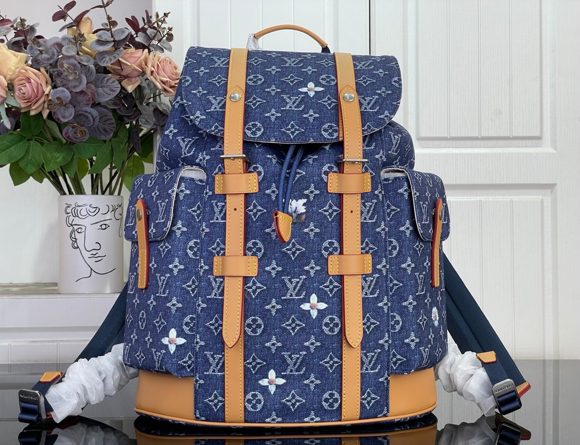 Louis Vuitton monogram canvas backpack with tan leather trim and top handle