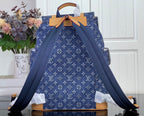 Louis Vuitton monogram canvas backpack with drawstring top and tan leather handles