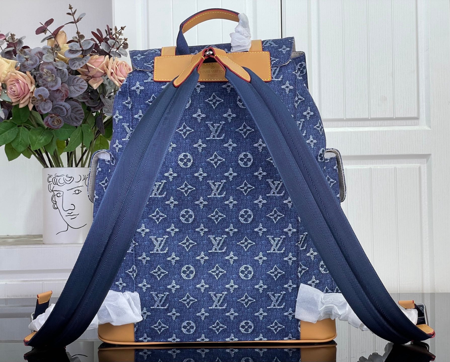Louis Vuitton monogram canvas backpack with drawstring top and tan leather handles