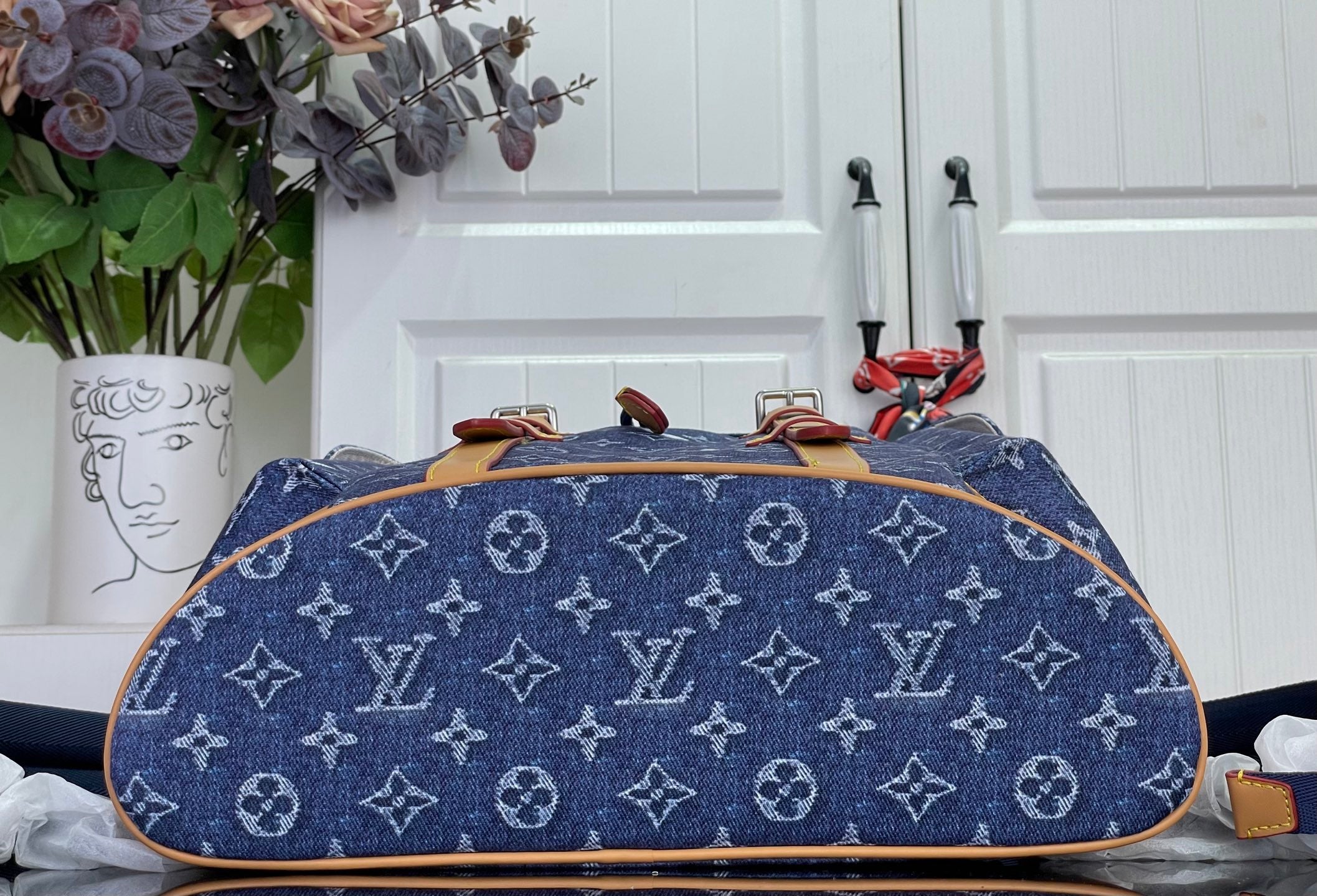 Louis Vuitton monogram canvas backpack with tan leather trim and wide top opening