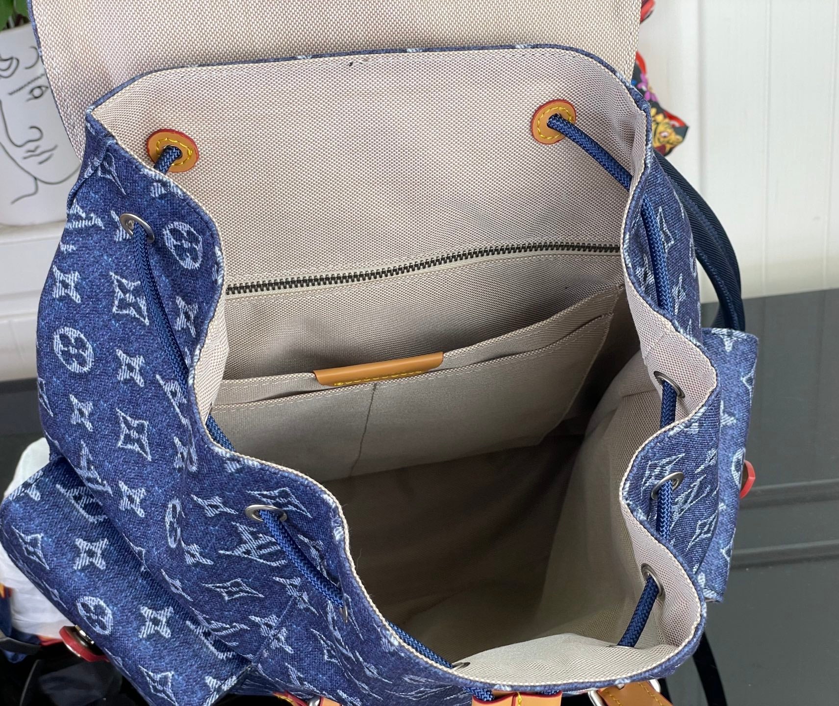 Louis Vuitton denim monogram tote bag interior, open top with beige lining.