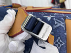 Louis Vuitton logo buckle securing dark blue strap on tan-trimmed monogram canvas