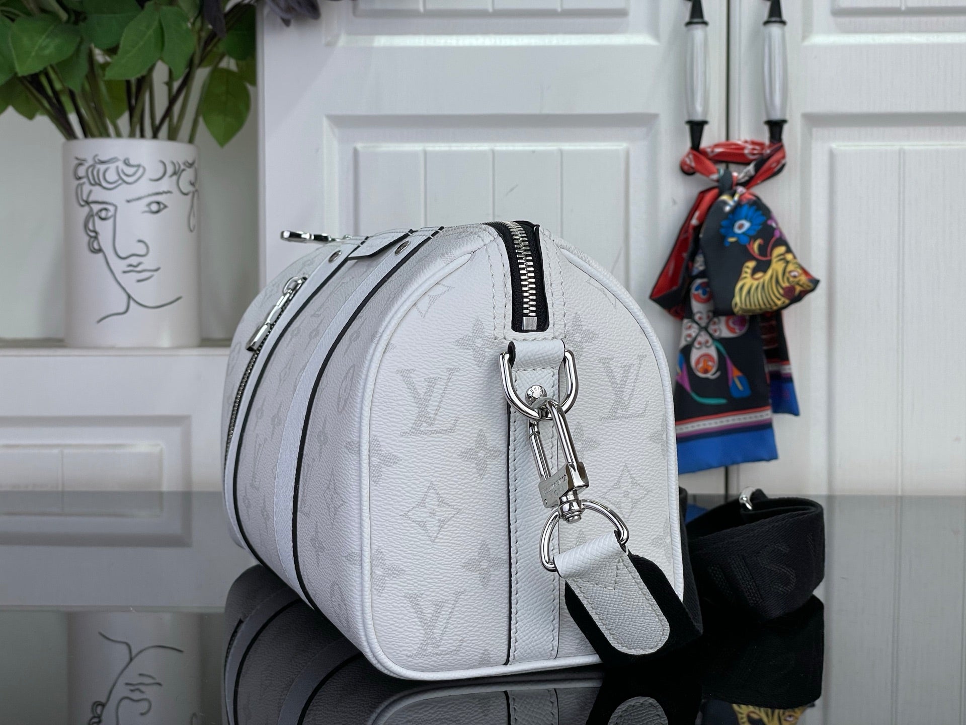 White Louis Vuitton monogram crossbody shoulder bag with curved strap and zipper