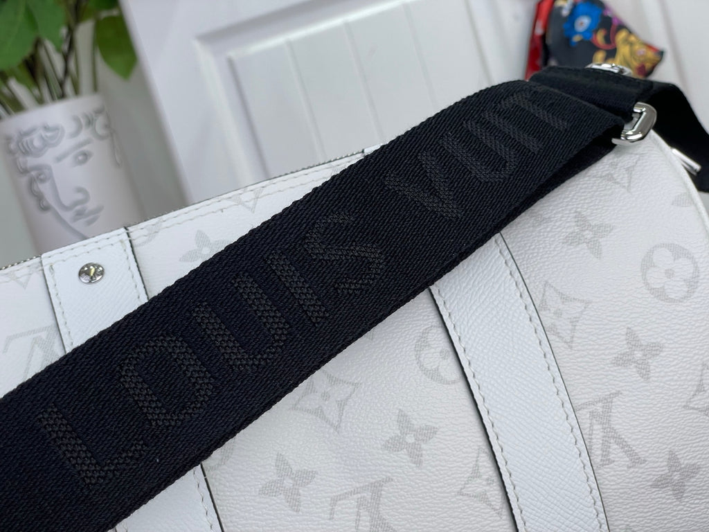 Black web strap with Louis Vuitton monogram detail over white textured bag