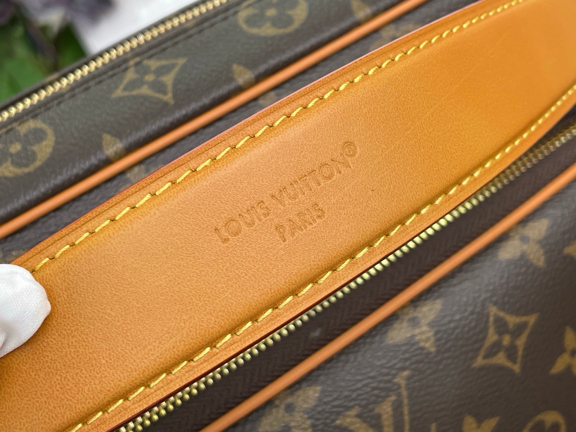 Louis Vuitton monogram bag inner zipper pocket with tan leather trim and stitching
